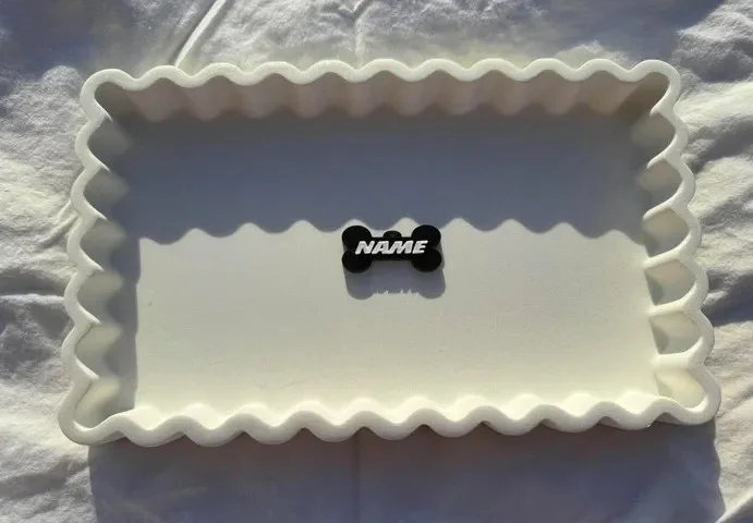 Front of a personalised bone-shaped pet tag